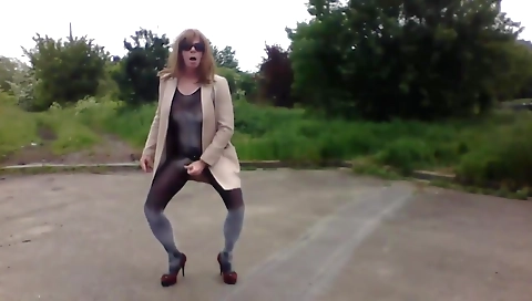 Female naked in the field masturbates on her hands and legs