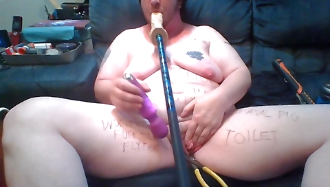 Busty brunette girl sucking a dick on a stick in fetish