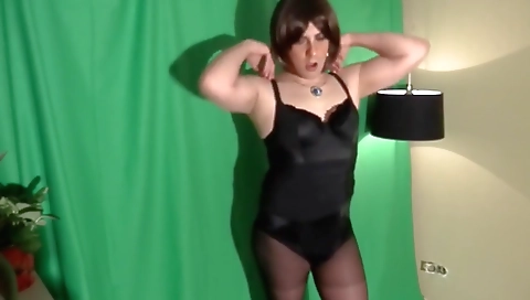 Naked shemale masturbates on camera in black dress