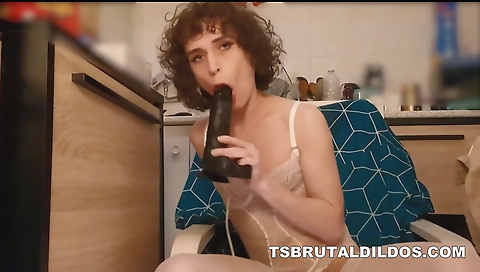 Trans shemale in black lingerie sucks a dildo in the bathroom